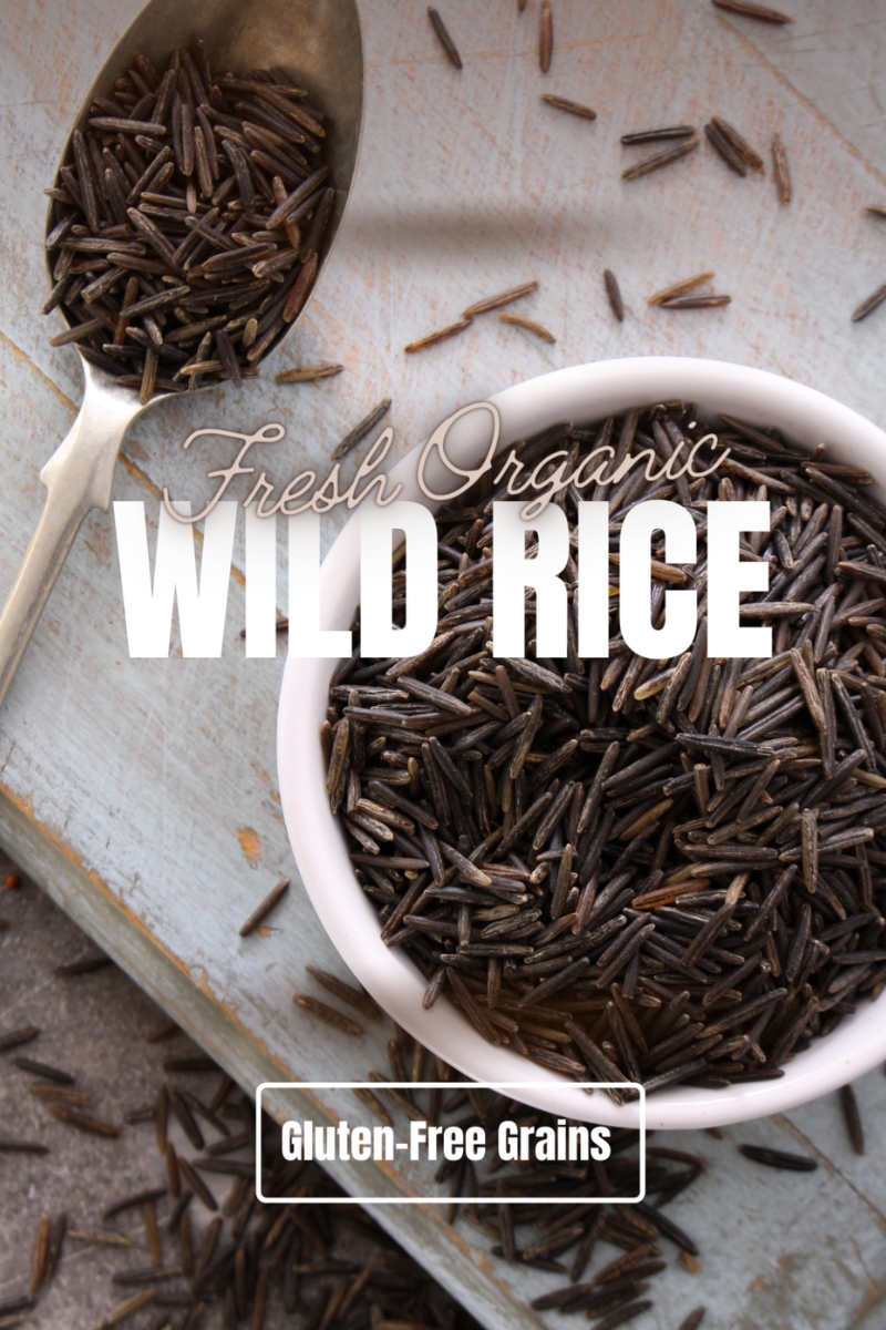 Fresh organic wild rice displayed in a rustic bowl, showcasing its natural texture and earthy tones.