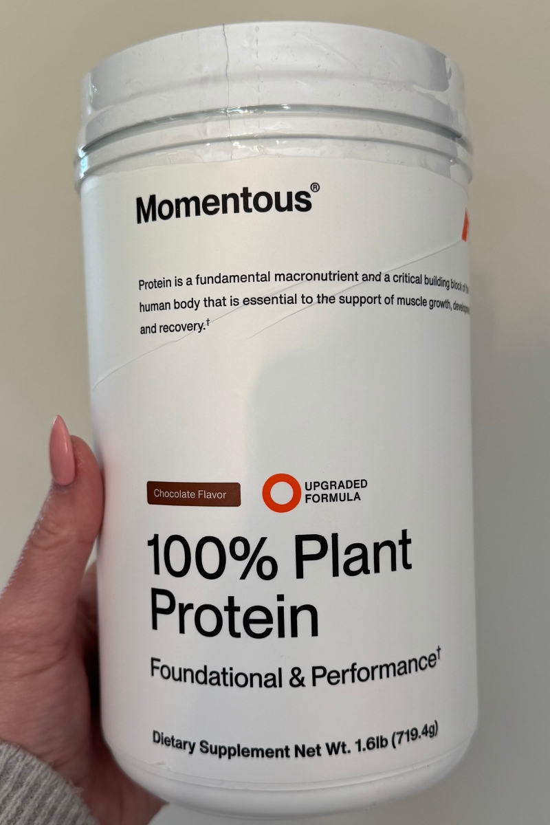Image of a product labeled "Momentous 100% Plant Protein," showcasing its packaging and highlighting its plant-based ingredients.