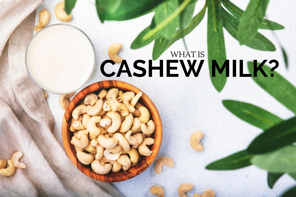 Visual of cashew milk in a clear glass, with whole cashews beside it, representing a dairy-free milk option.